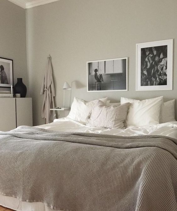 a soothing greige bedroom with neutral furniture, floating nightstands, a mini gallery wall and neutral and white textiles is very welcoming