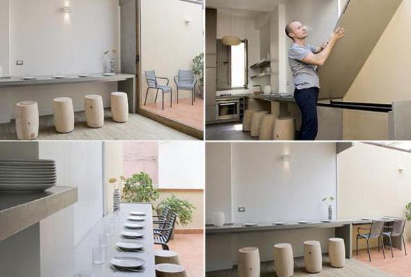 Modern interior and modern living-dining room with a concrete dining table along the wall and round wooden stools