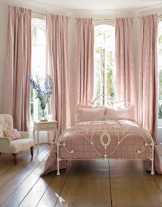 a vintage feminine bedroom with elegant white furniture, pink linens and textiles and nothing else is beautiful