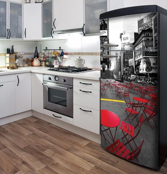 kitchen equipment with white kitchen cabinets, parquet flooring and black retro refrigerator with stickers