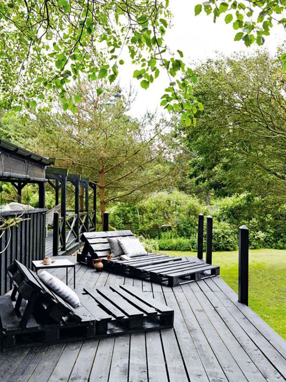 attractive garden idea with self-made garden loungers in black as a suitable facility for a black wooden terrace in the garden